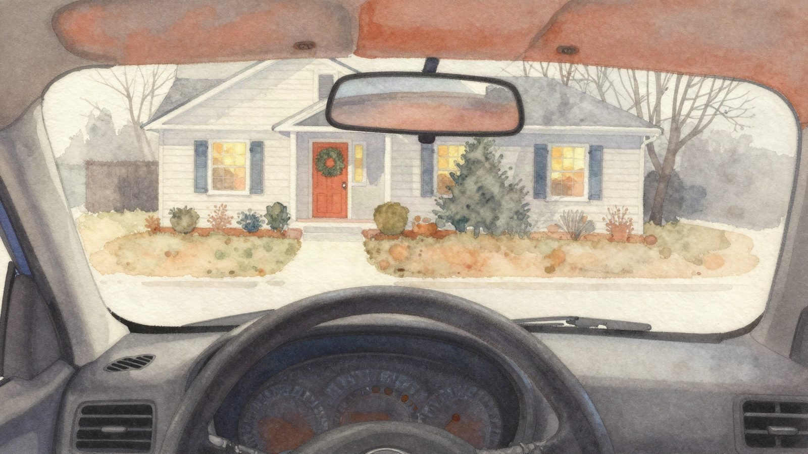 A front door with a wreath, seen from a parked car on a gray afternoon.